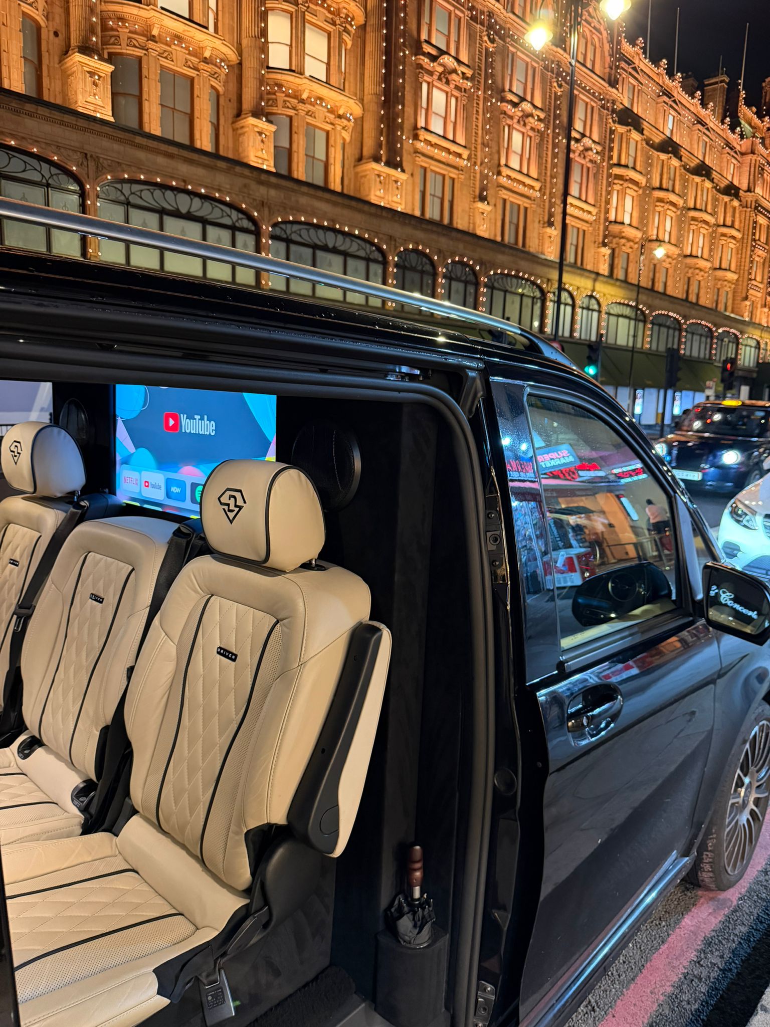Open V-Class door revealing cream seats outside Harrods
